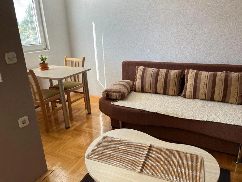 a couch and dining area at the side