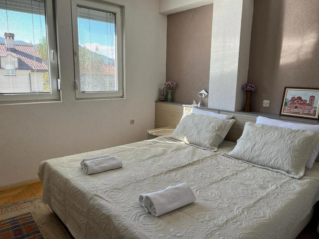 bedroom with a window and white clean sheets bedroom with a window and white clean sheets