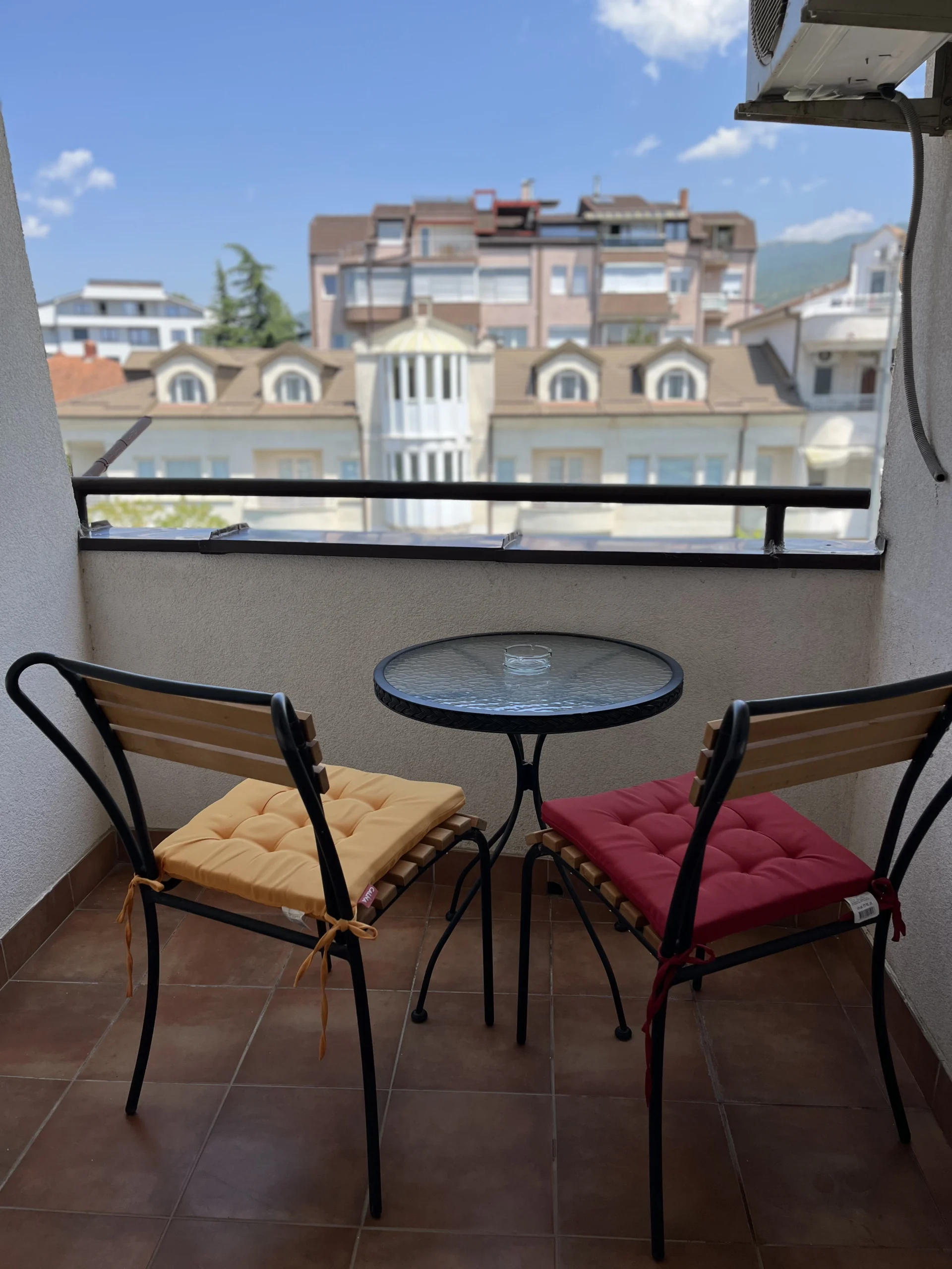 chairs in the balcony on a sunny day with a view