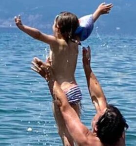 little girl thrown from the water with dad edited